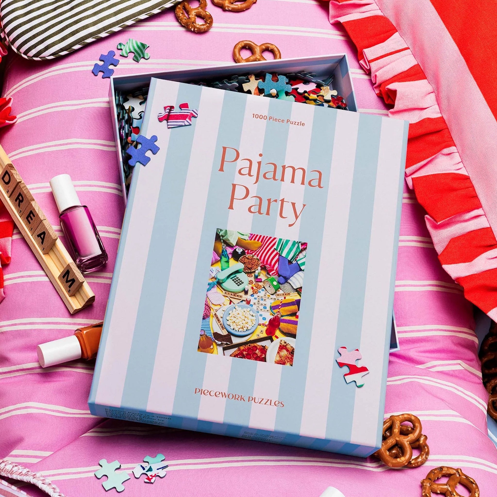 A pajama party themed puzzle with a striped box that reads, "1000 Piece Puzzle Pajama Party". 