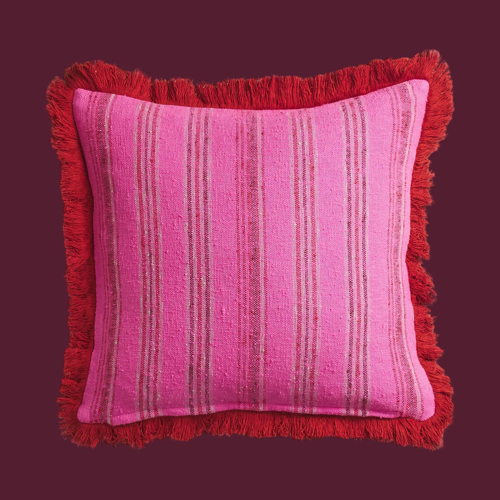 A pink and red striped pillow. 