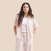 An eyelet pink short sleeve button up. 