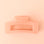 On a light pink background is a nectar pink rectangle shaped hair clip.