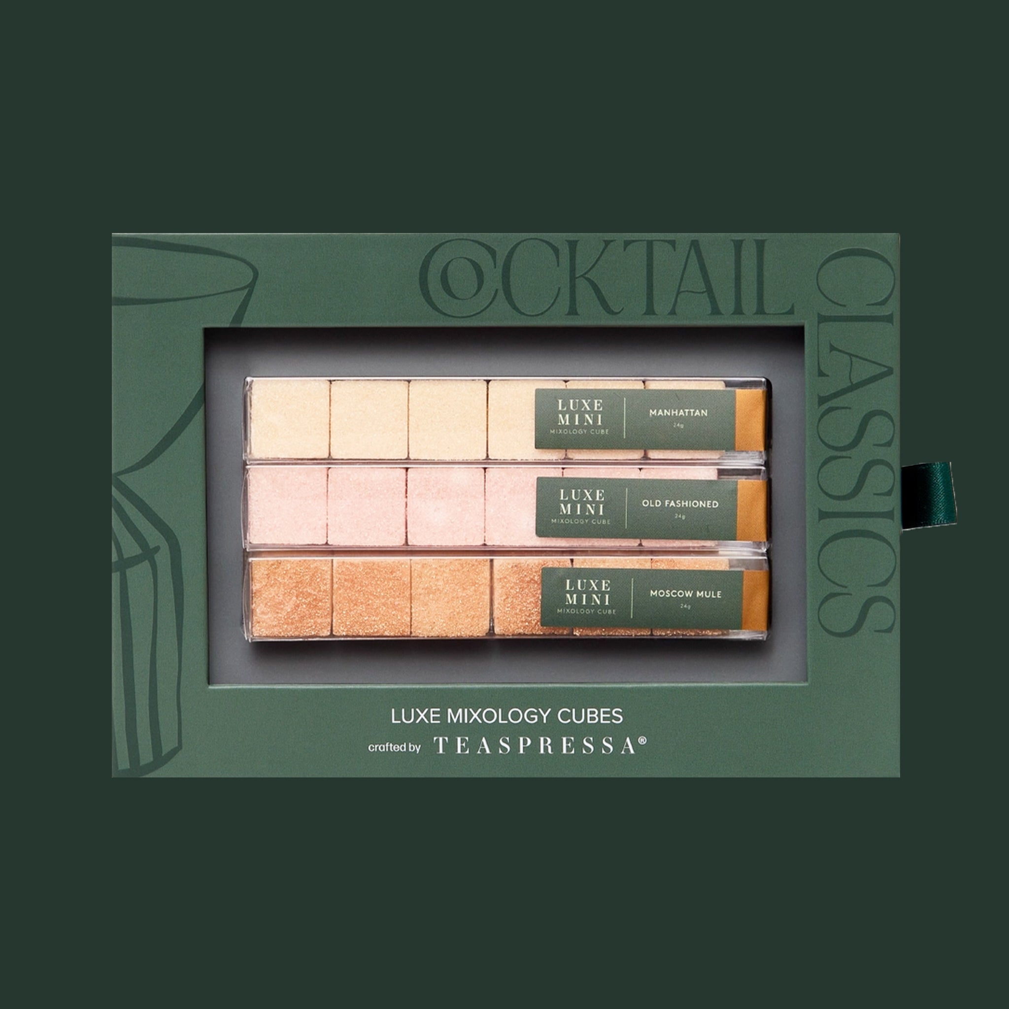A green box filled with three packs of flavored sugar cubes and text that reads, "Cocktail Classics Luxe Mixology Cubes Teaspressa". 