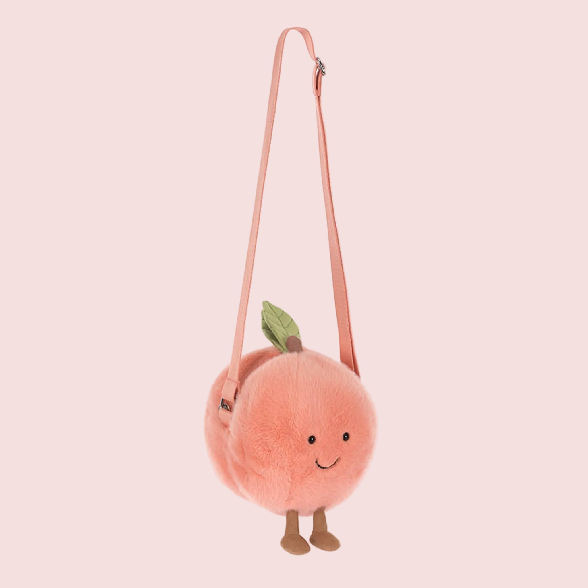 A peach stuffed toy shaped crossbody bag. 