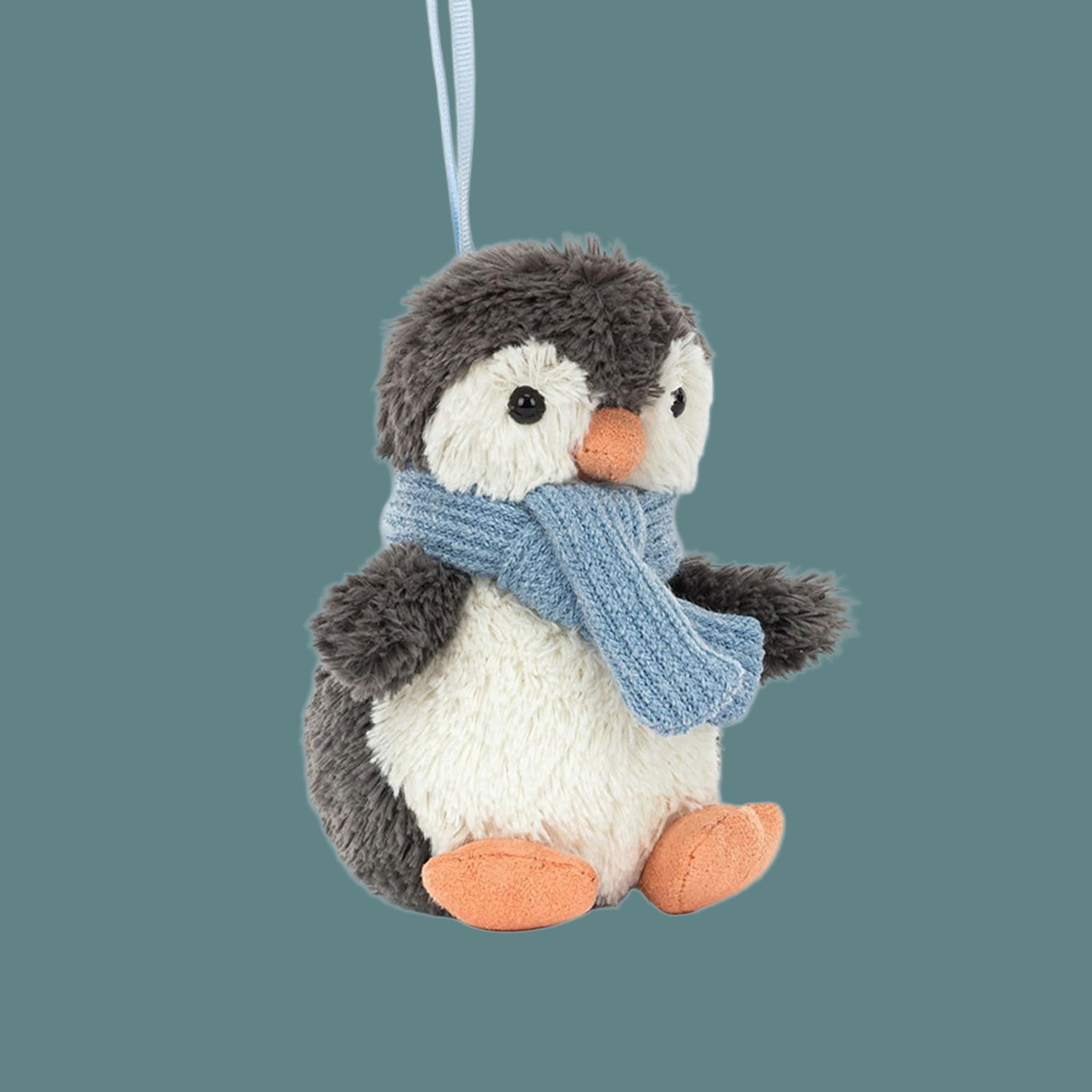 A mini stuffed animal penguin shaped ornament. 