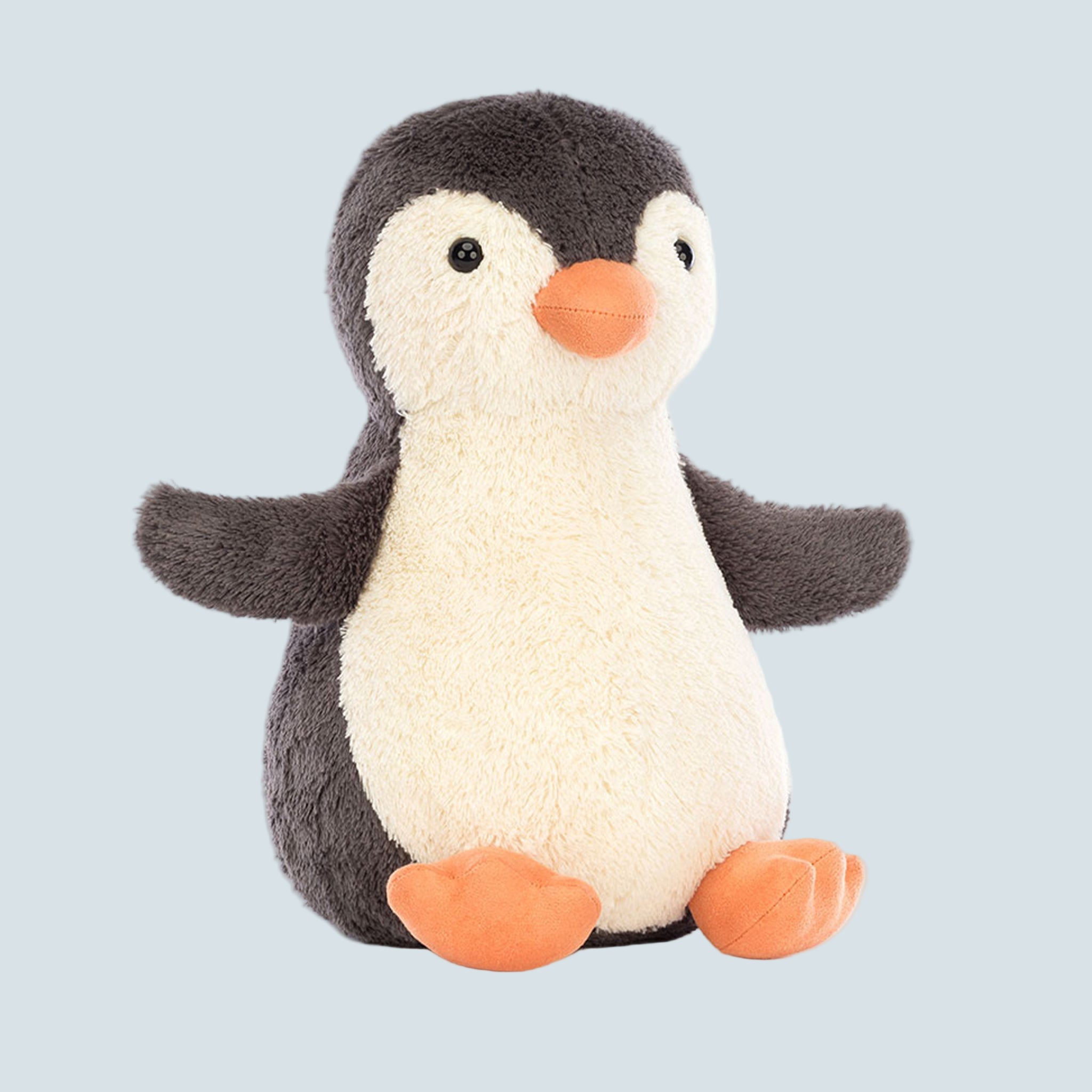 A penguin shaped stuffed toy animal. 