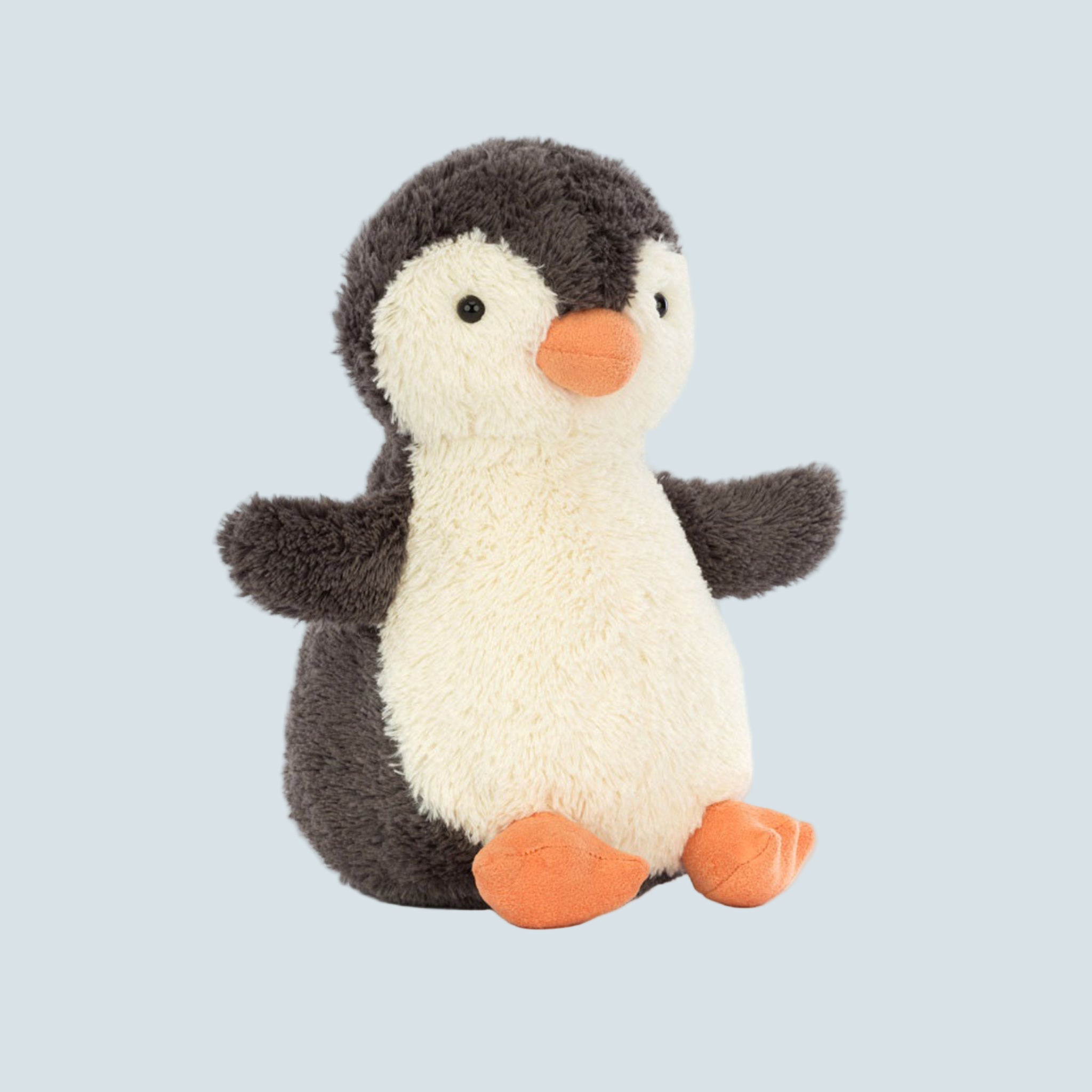 A penguin shaped stuffed toy animal. 