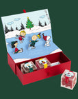 A three piece box of assorted candies with the characters of Peanuts on the boxes. 