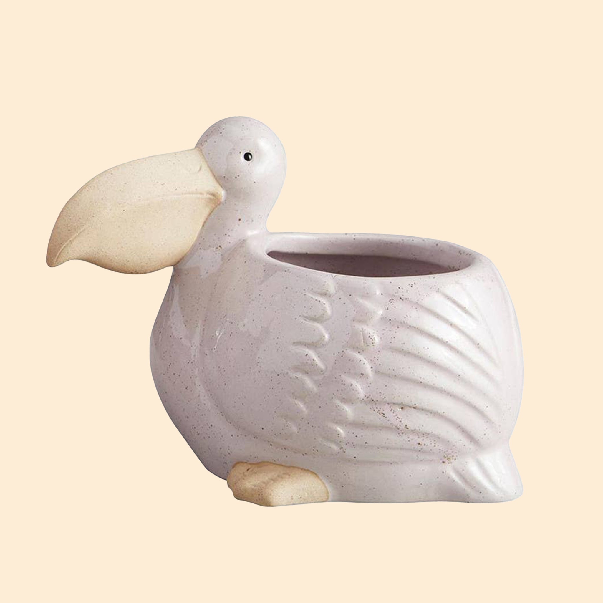 A neutral pelican shaped planter. 