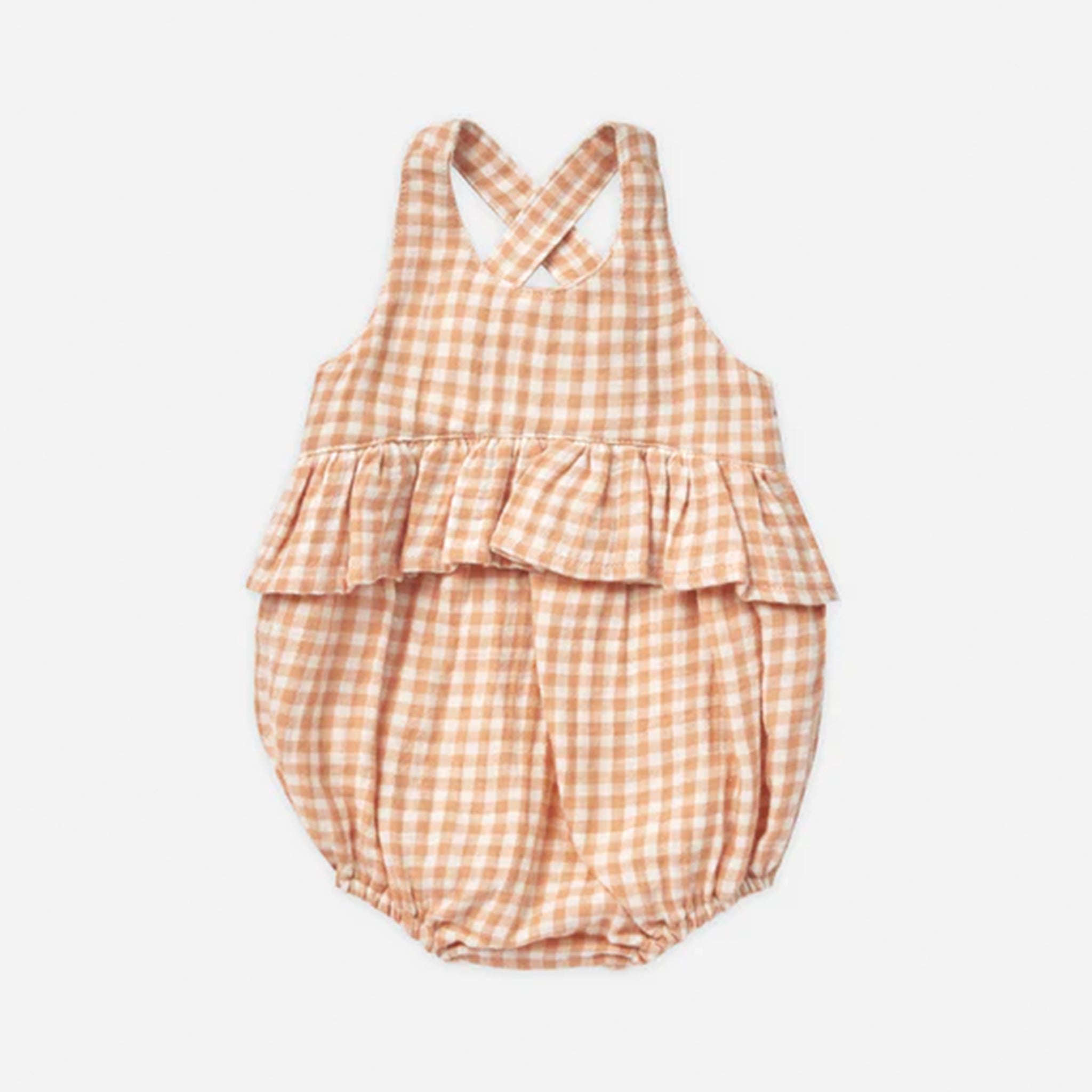 An ivory and light orange one piece children&#39;s romper with a criss cross detail on the back and snap closures on the bottom for easy changing.