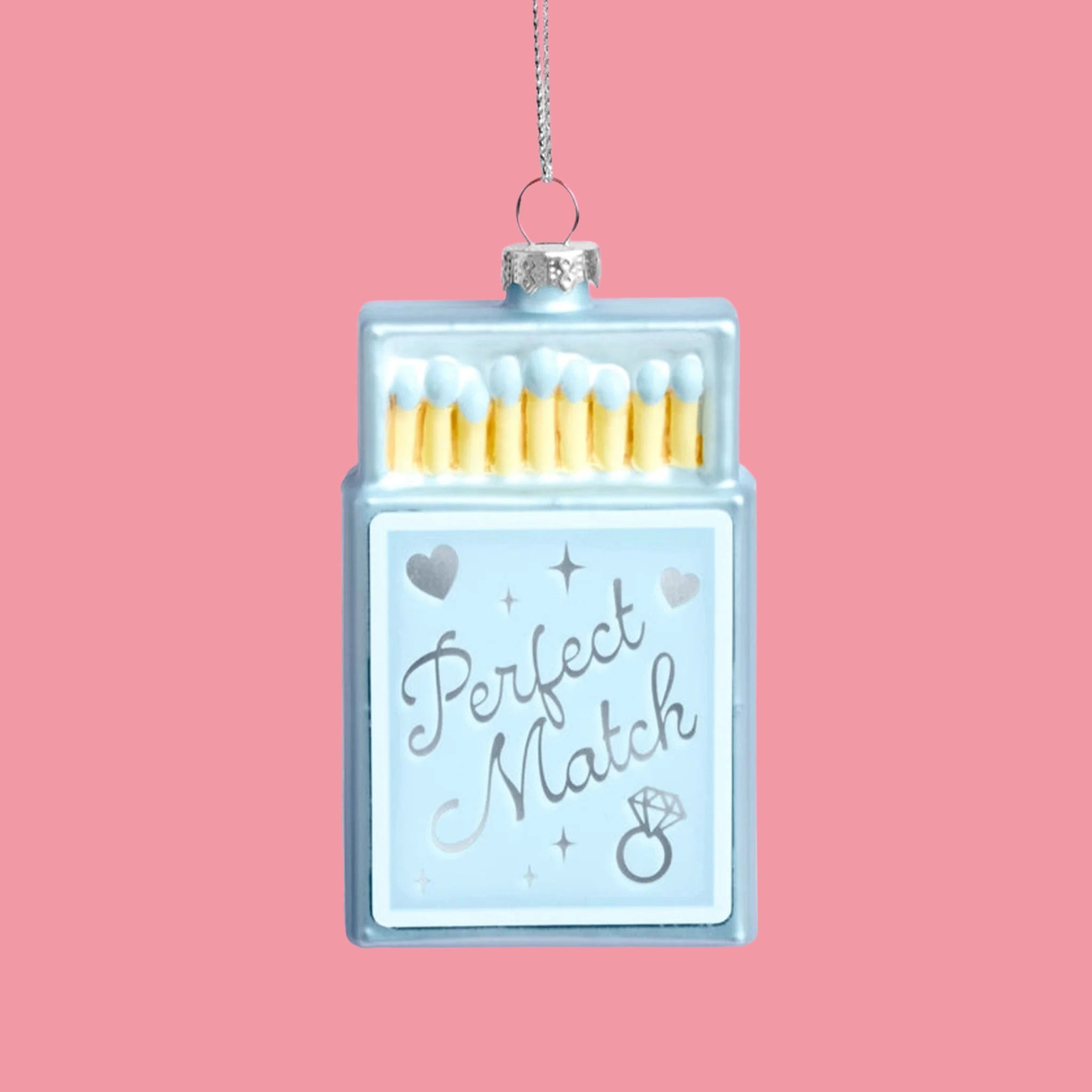 A blue matchbox shaped ornament that reads, "Perfect Match". 