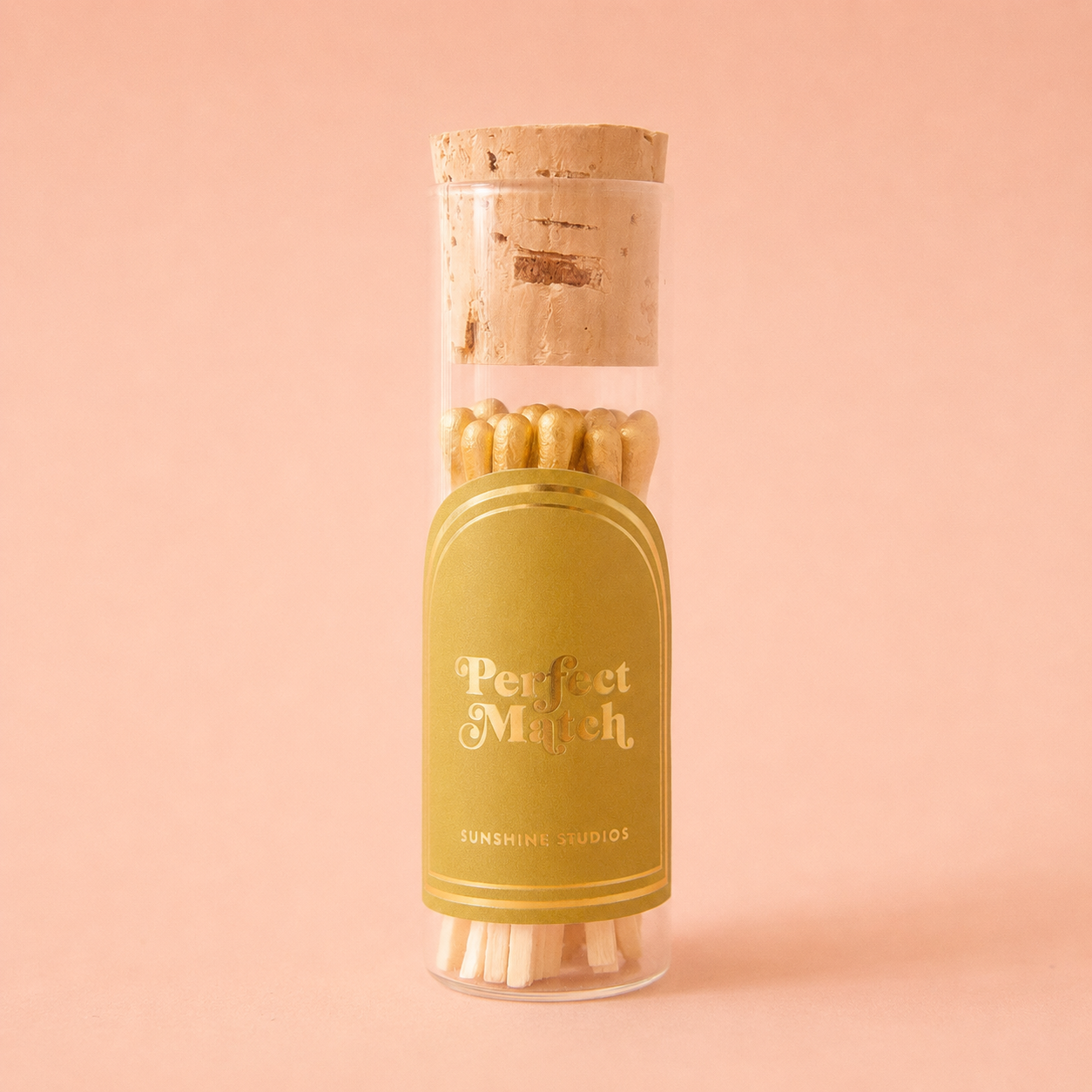 A small glass vial of wooden matches with a label that reads, 'Perfect Match'. 