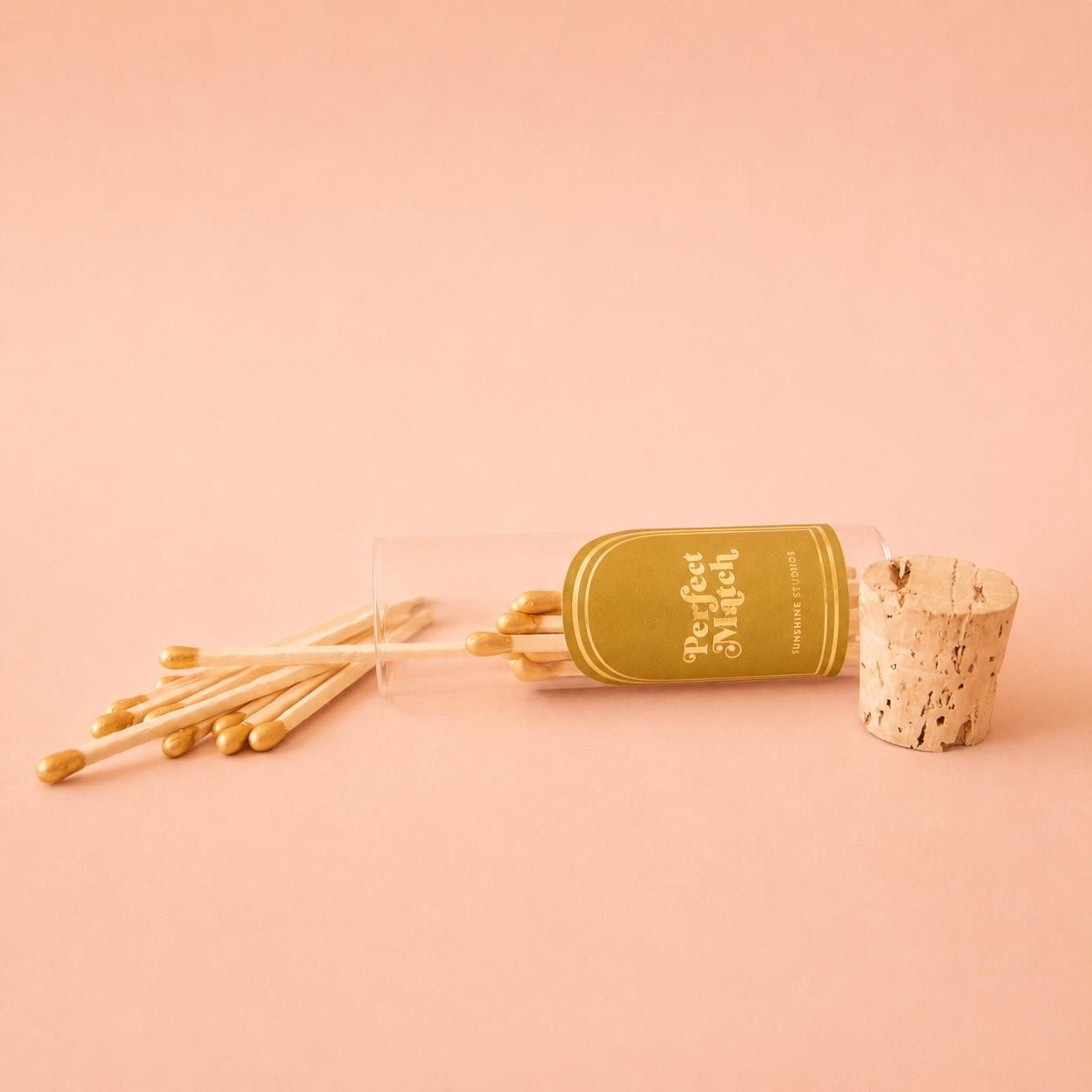 A small glass vial of wooden matches with a label that reads, 'Perfect Match'. 