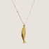 A gold chain necklace with a fish pendant on the end. 