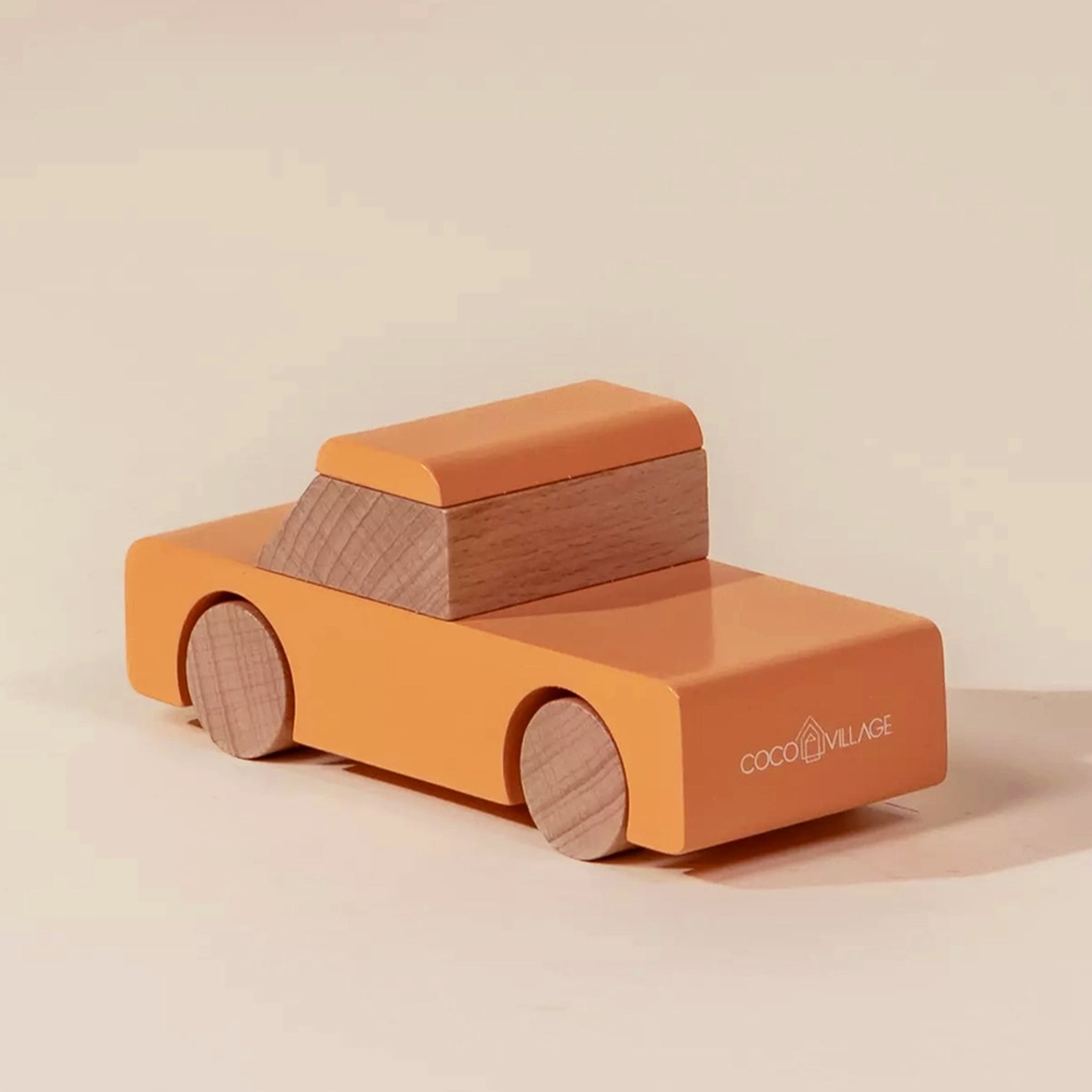 An orange wooden pickup truck shaped toy. 
