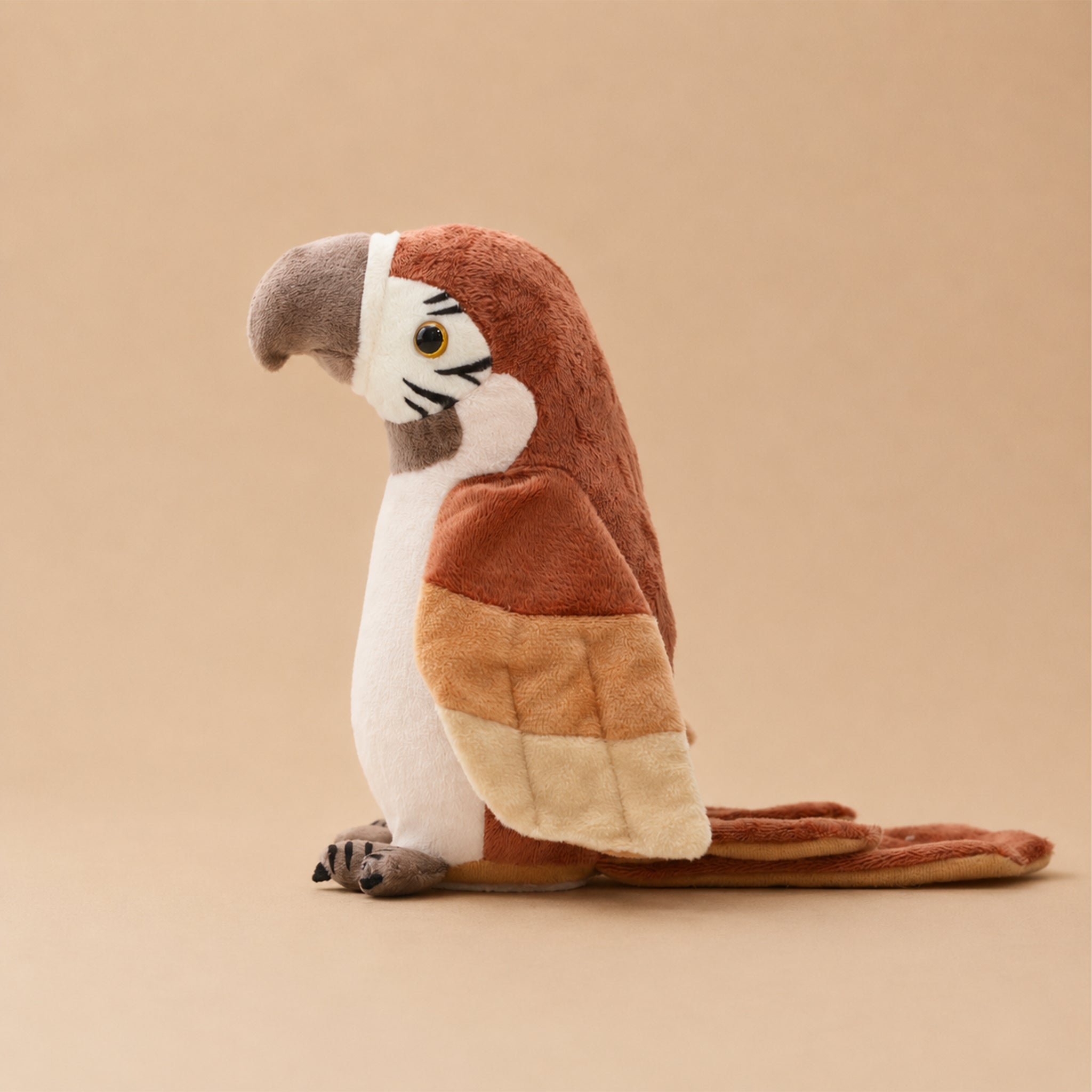 Plush parrot toy on a beige background