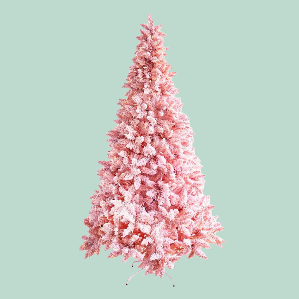 Pink artificial Christmas tree on a light green background