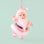 santa figure ornament with a light pink coat on a mint background.