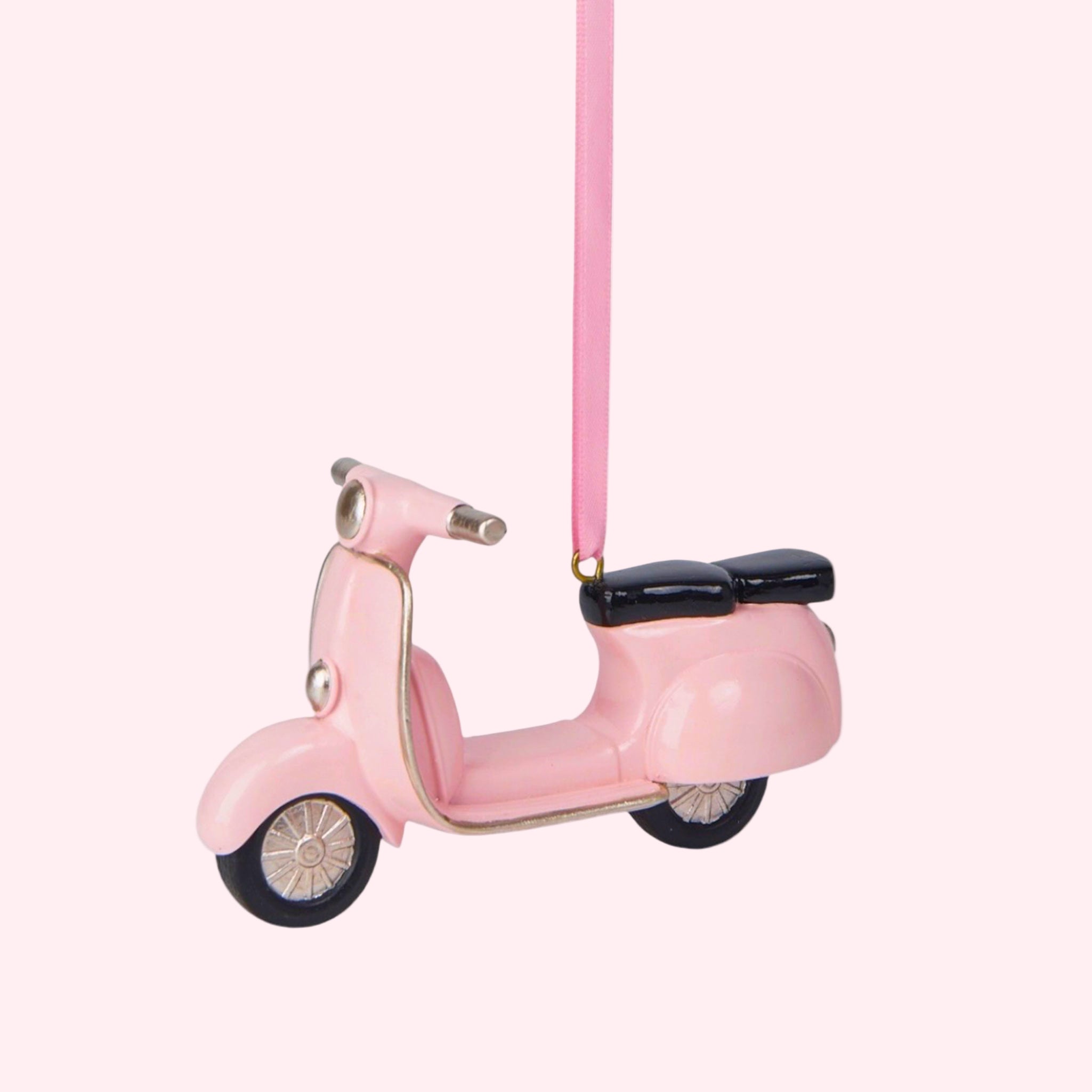 A pink scooter shaped Christmas tree ornament.