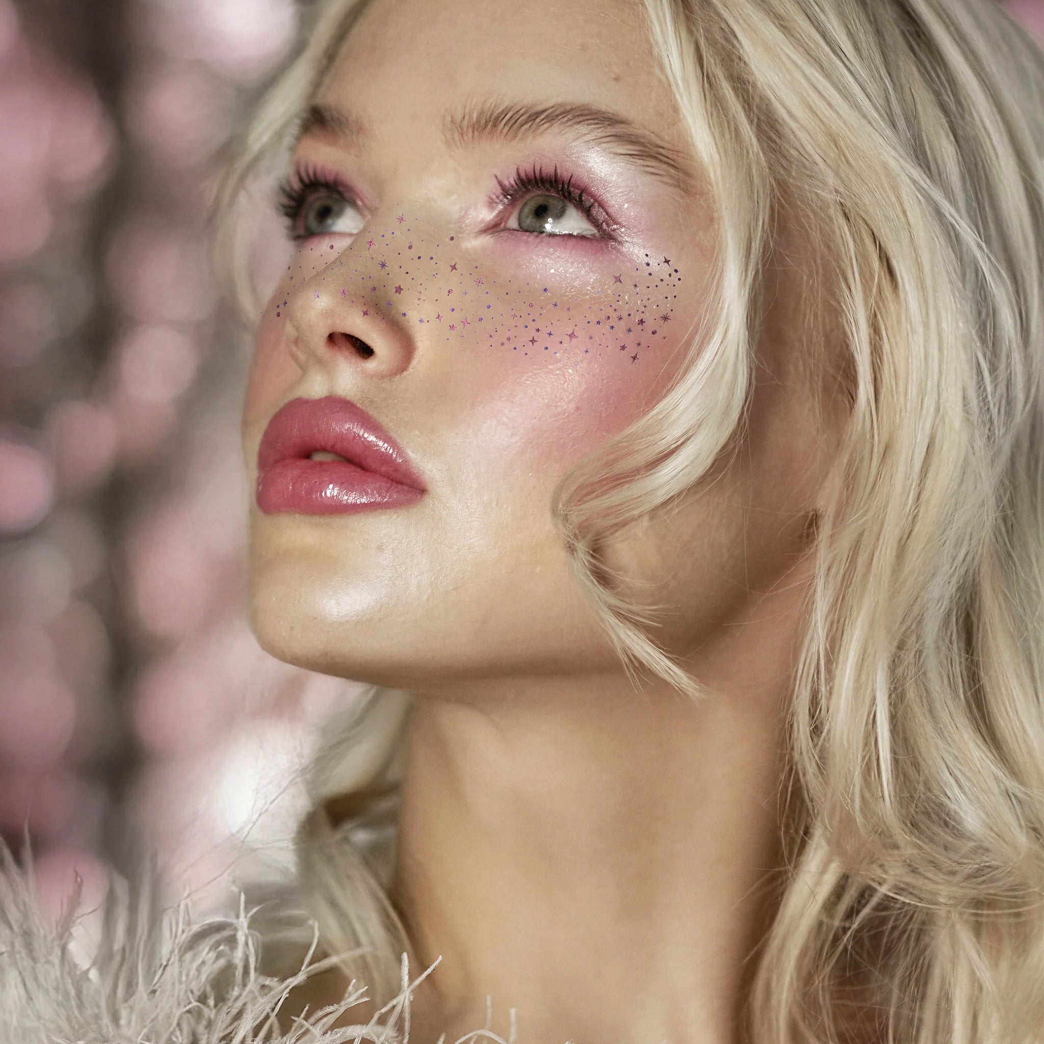 A model wearing a pink sparkle freckles. 