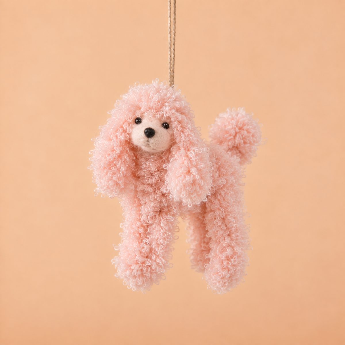 A pink poodle shaped ornament. 