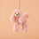 A pink poodle shaped ornament. 