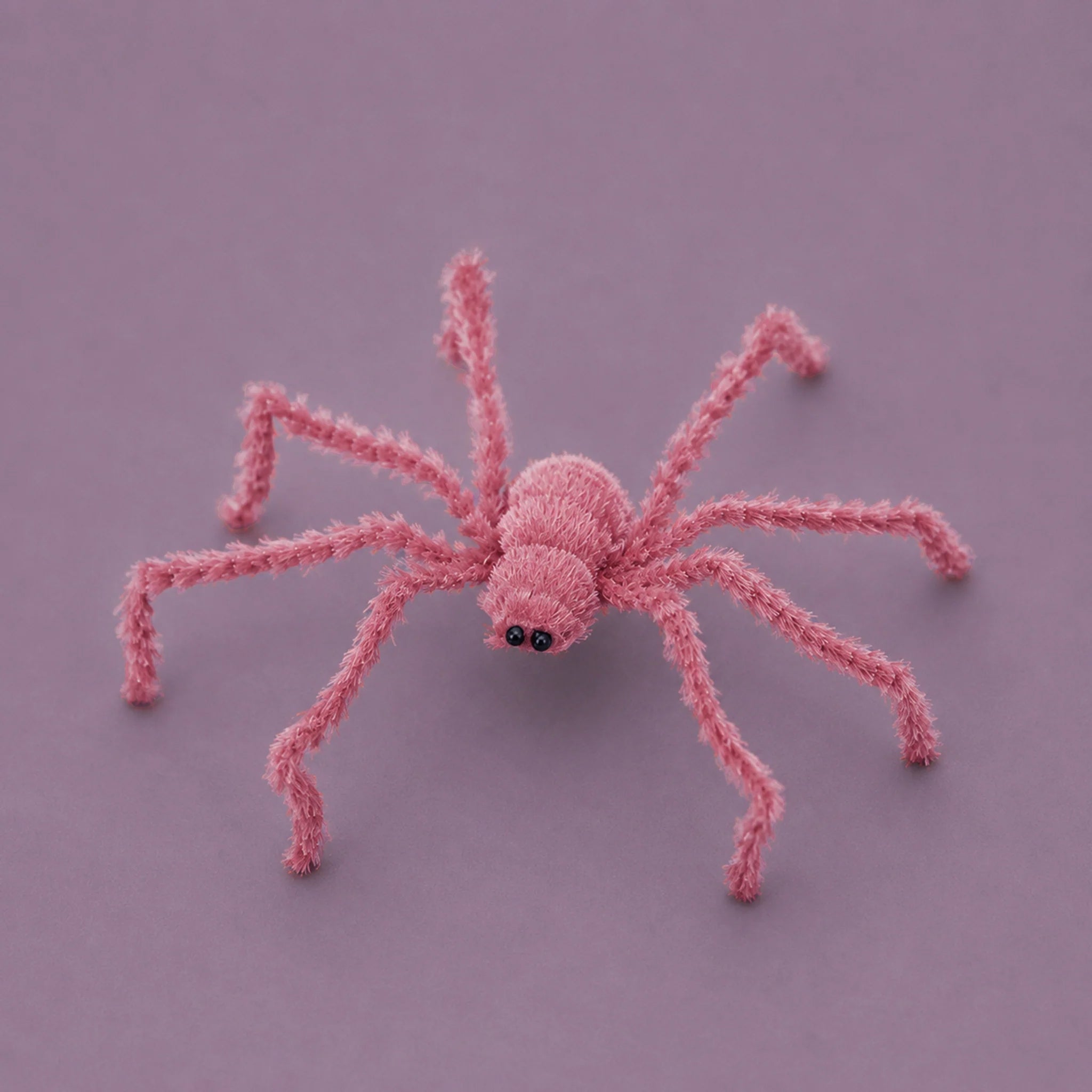 A pink furry spider decoration.