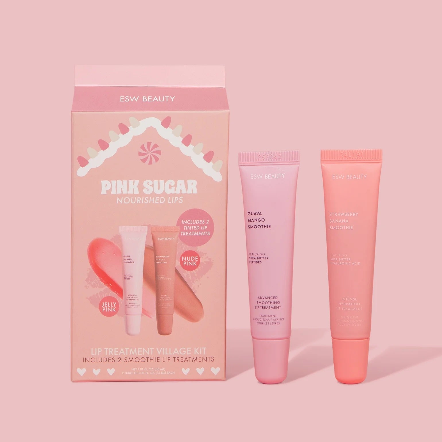 ESW Beauty ‘Pink Sugar Nourished Lips’ kit box next to two tinted lip treatment tubes—light pink ‘Guava Mango Smoothie’ and coral ‘Strawberry Banana Smoothie’—on a soft pink background.