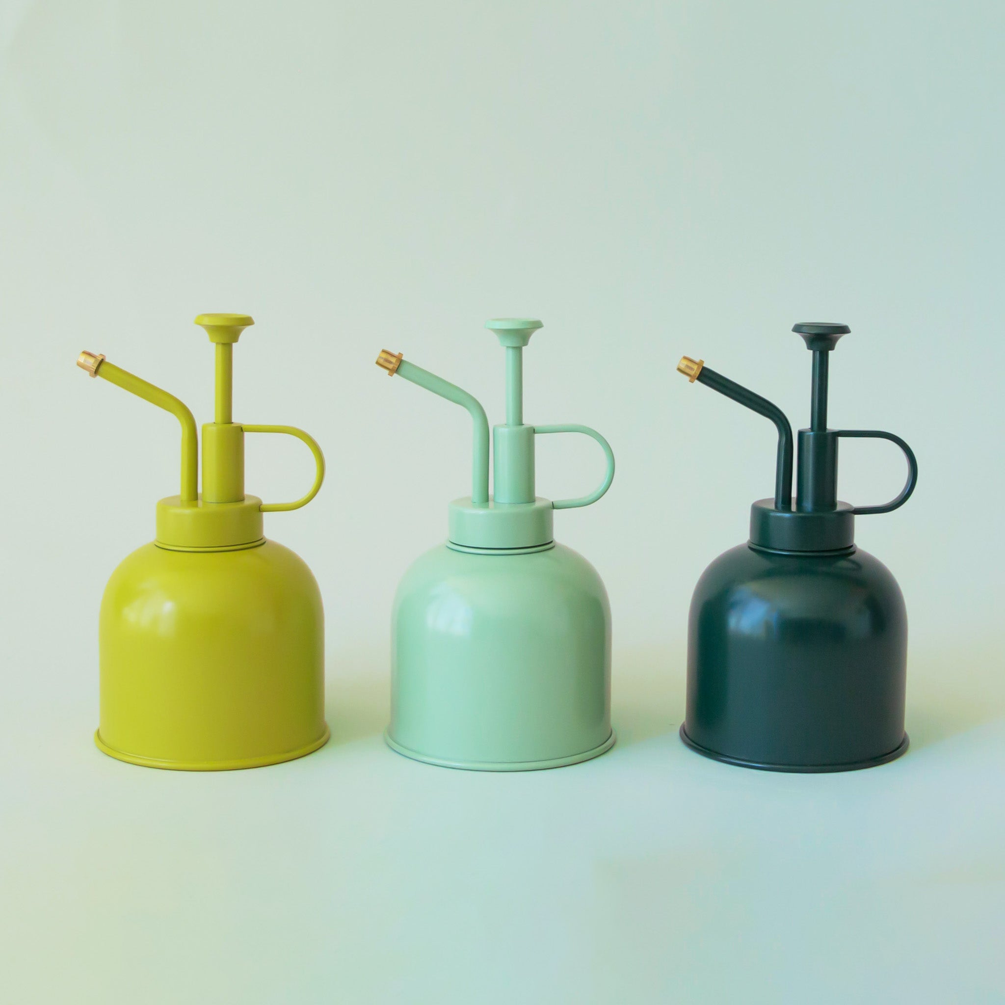 Three plant misters in a chartreuse, mint and rainforest green. 