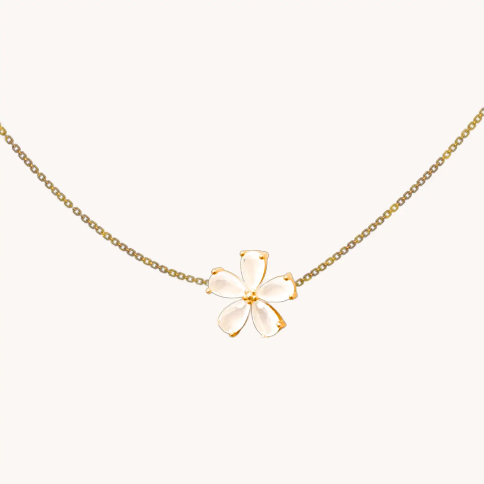 A plumeria flower gold chain necklace. 