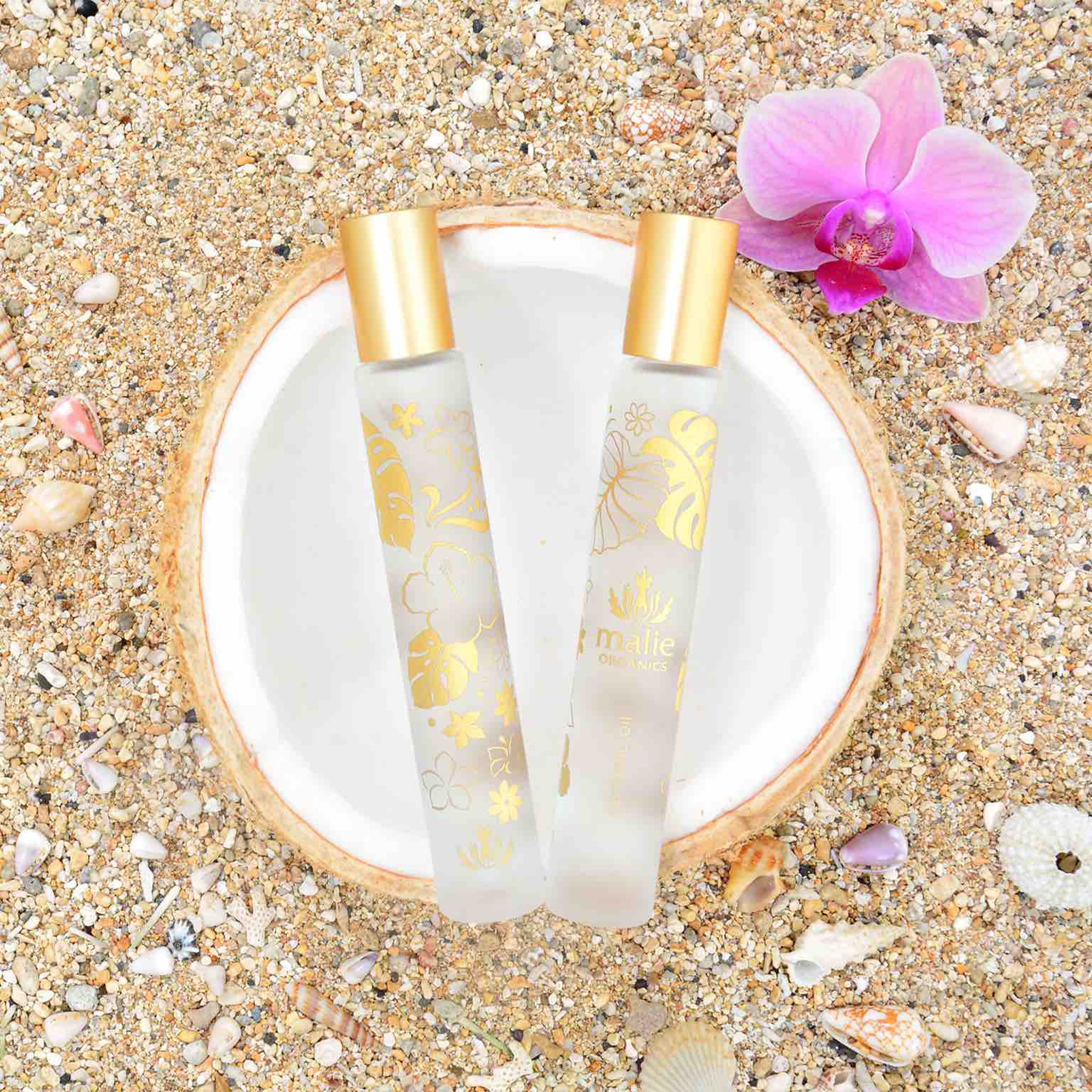 A rollerball perfume oil with a gold cap and monstera designs on the bottle.