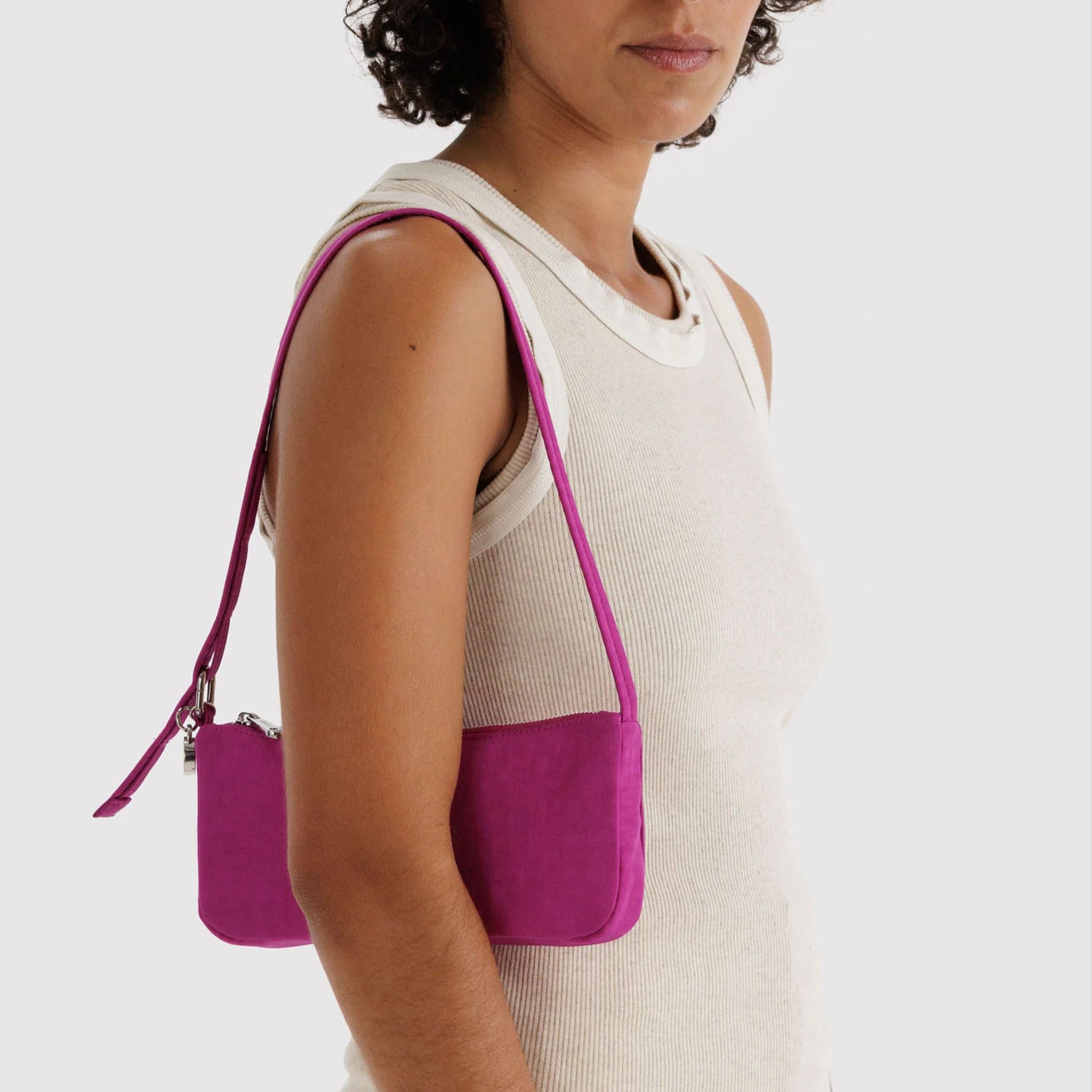 A hot pink mini shoulder bag. 