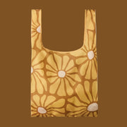 A yellow foldable daisy printed tote bag. 