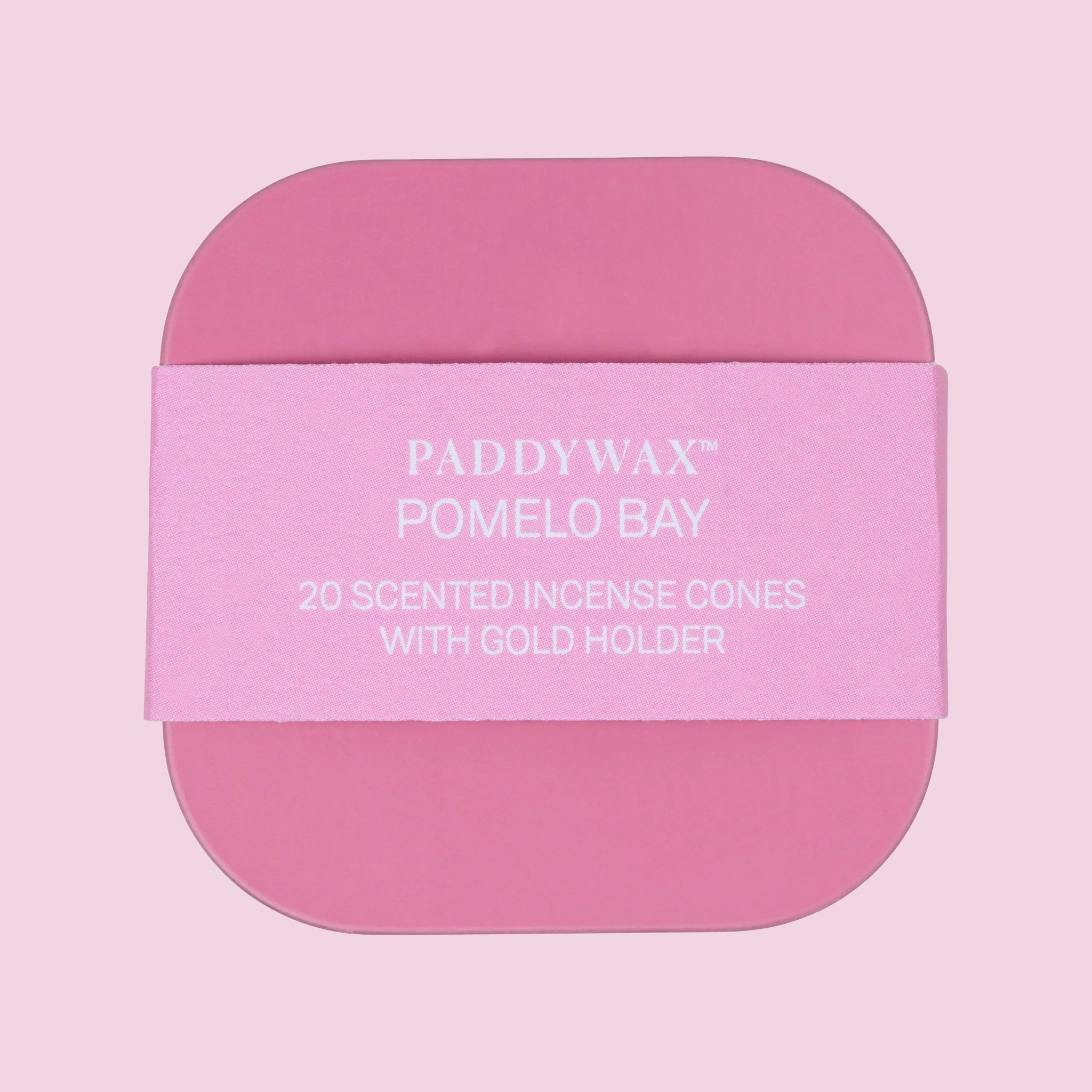 A pink box of incense cones and a gold small bowl for setting. 