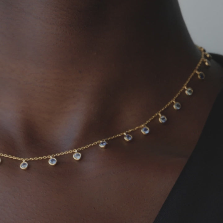 A chain necklace with round cz charms. 