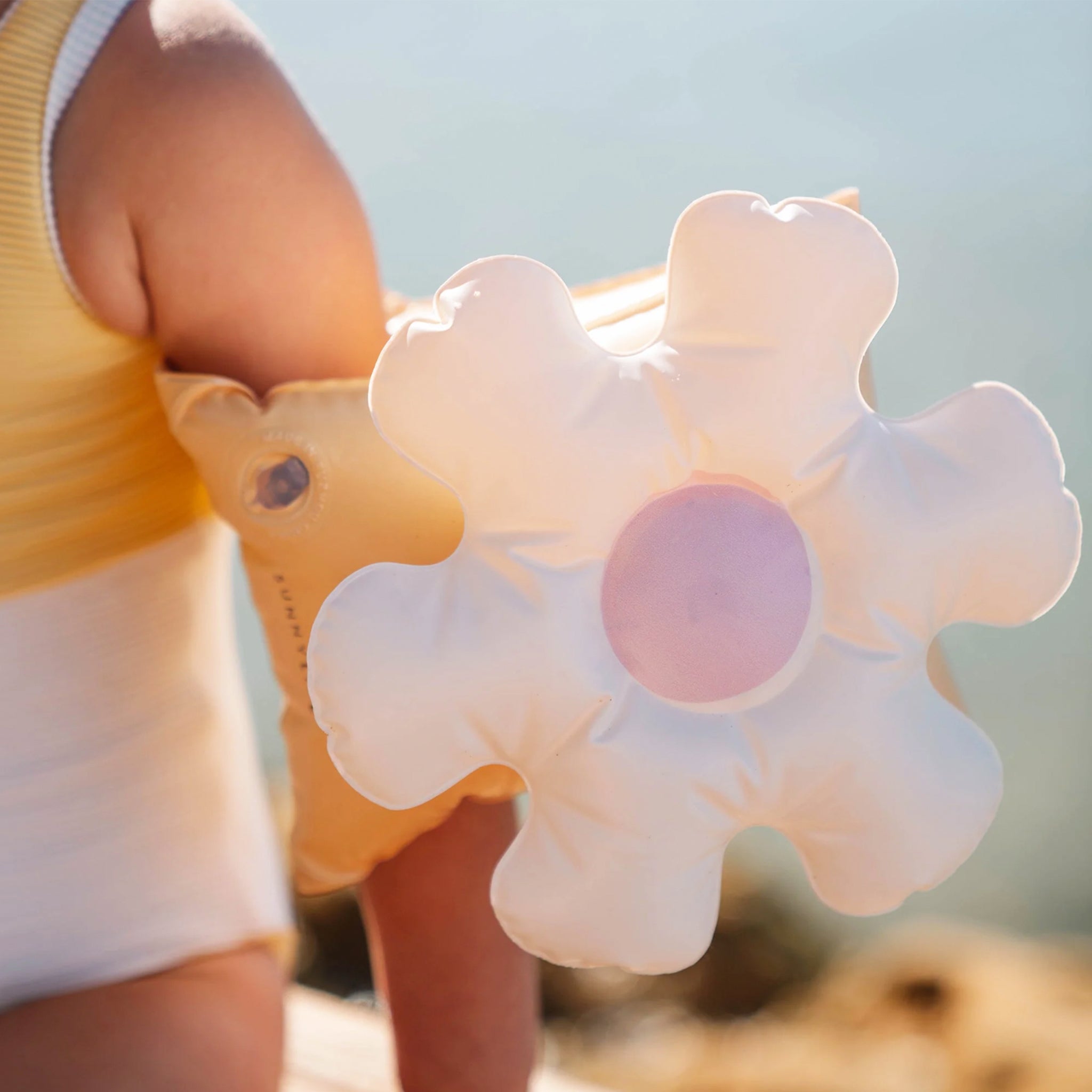 A flower shaped arm band floaty for kids. 