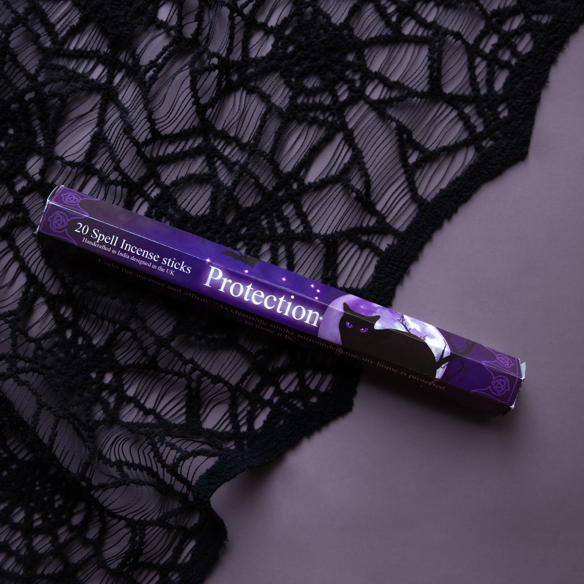 A dark purple package of 20 incense sticks that reads, '20 Spell Incense sticks Protection'. 
