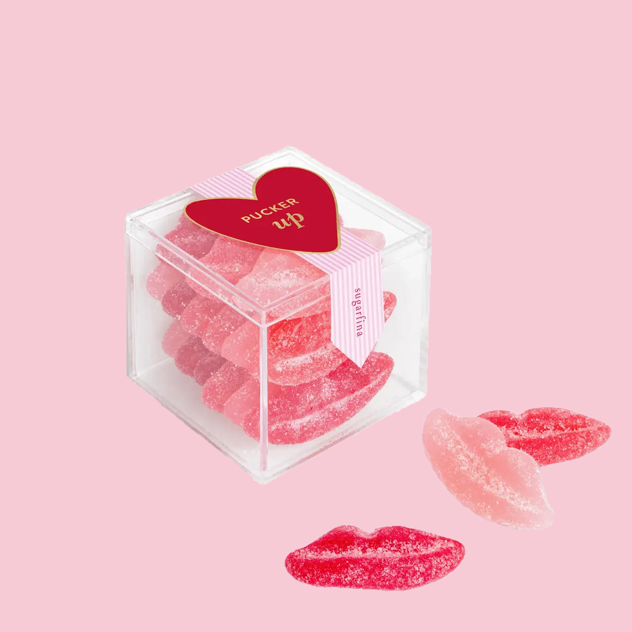 "Pucker Up sugarfina" acrylic box of lip shaped sour candies.