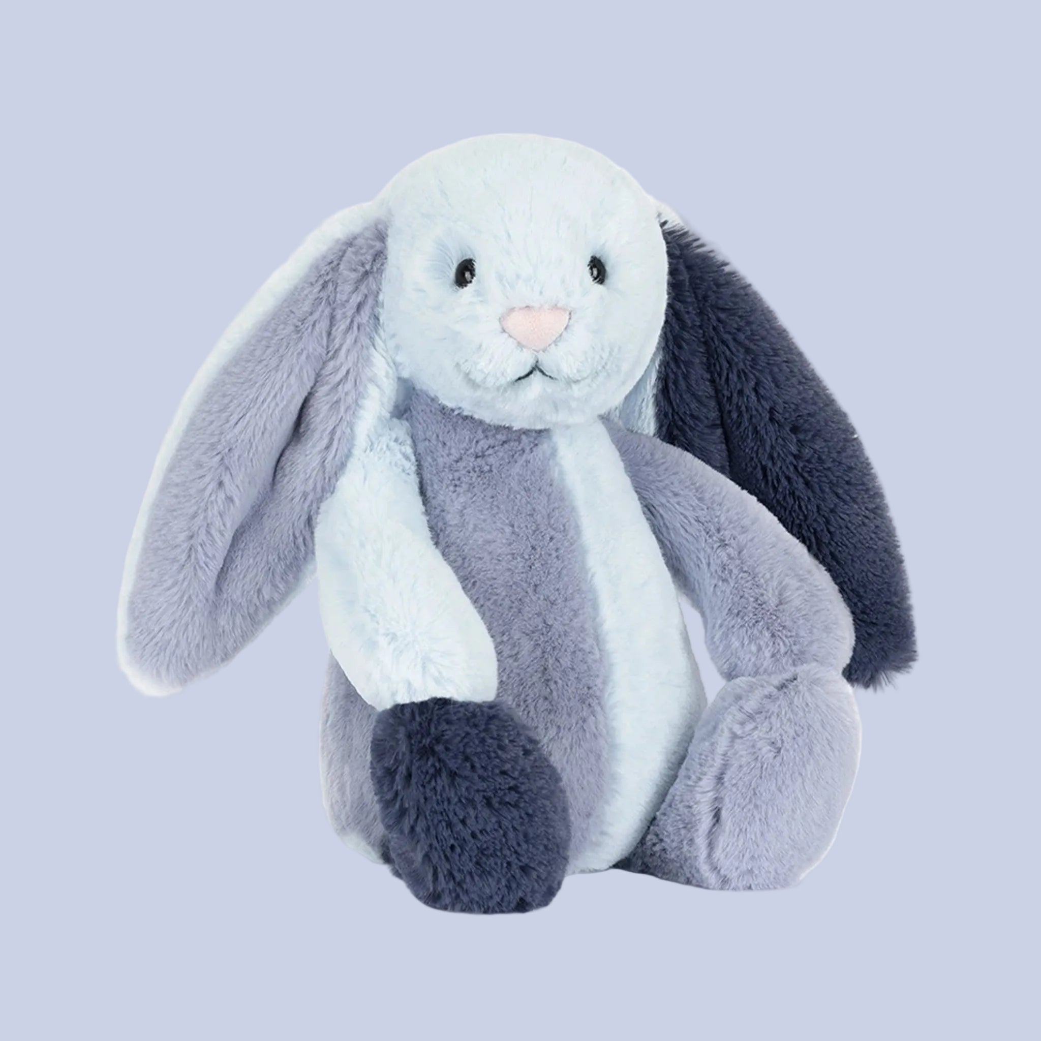 Plush toy rabbit with gray and white fur on a white background