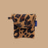 A brown and black leopard print earbud case. 