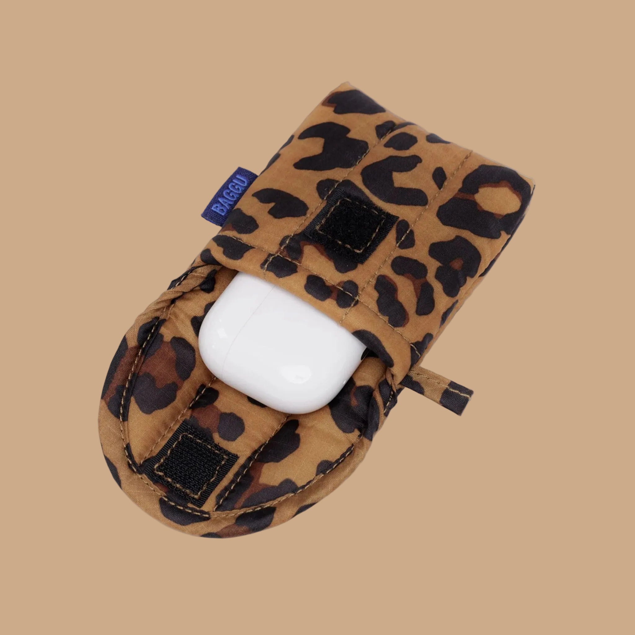 A brown and black leopard print earbud case. 