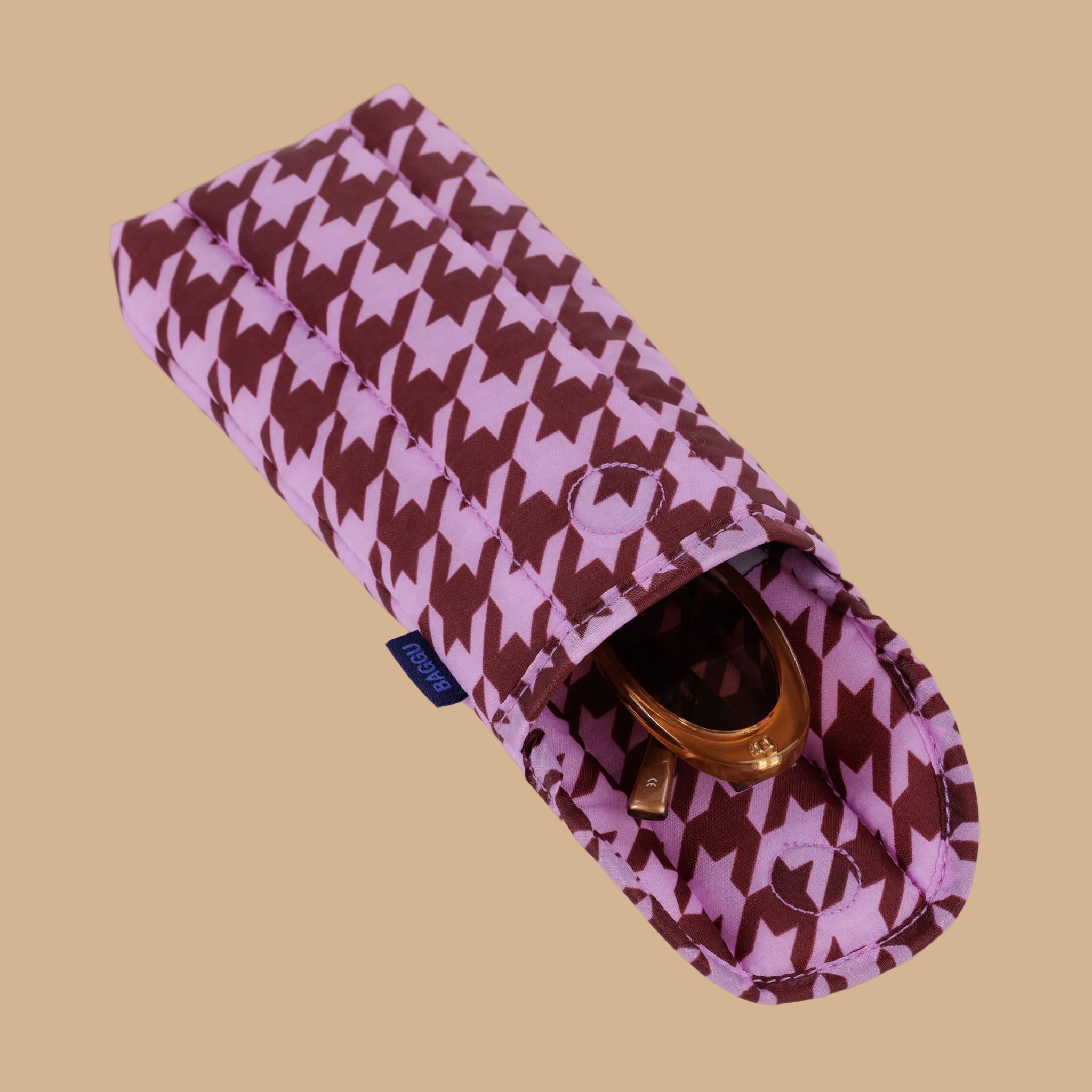 A pink and burgundy puffy glasses case.
