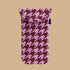 A pink and burgundy puffy glasses case.