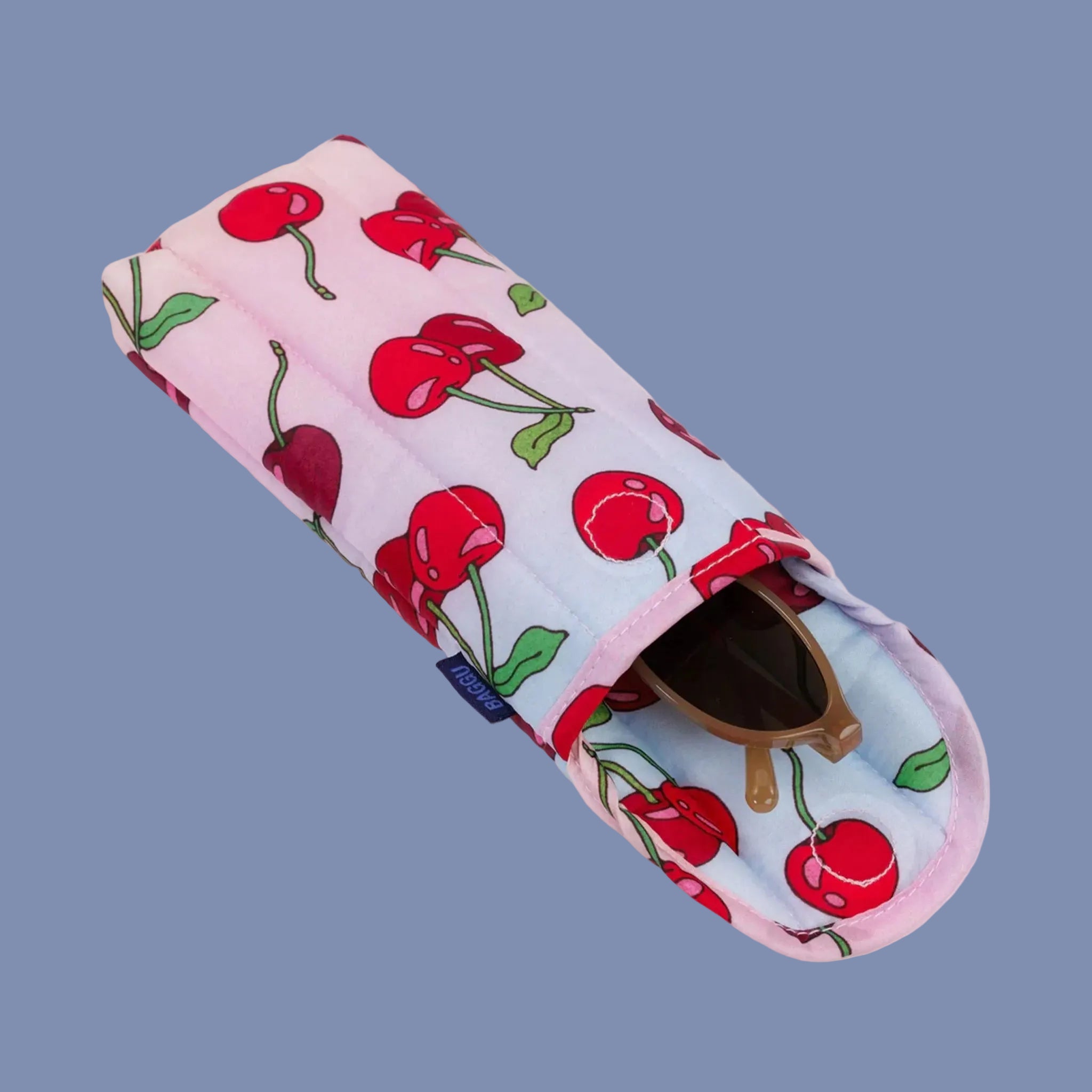 A blue and pink ombre puffy eyeglass case with a cherry print.  Glasses not included. 