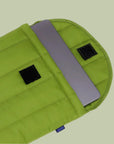 A green puffy laptop case with a velcro closure. 