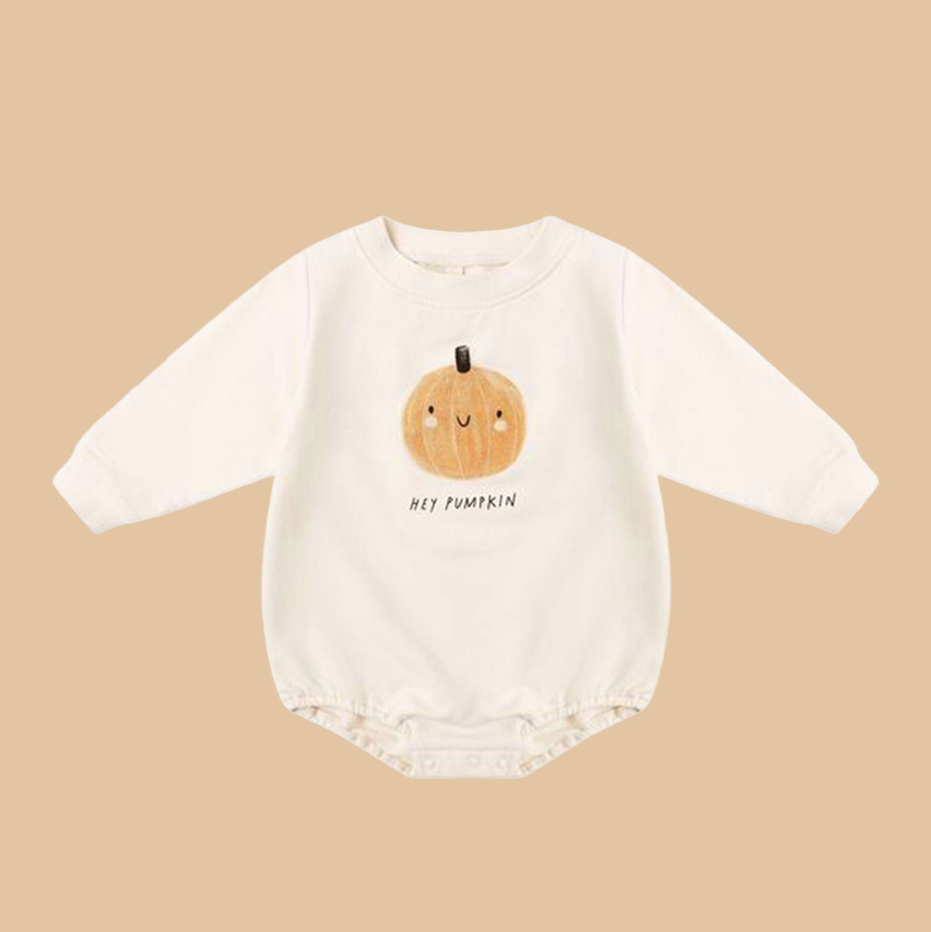 Kids white bubble romper with long sleeves and snap closure. There is a smiling pumpkin decal on the front and reads 'Hey Pumpkin'.