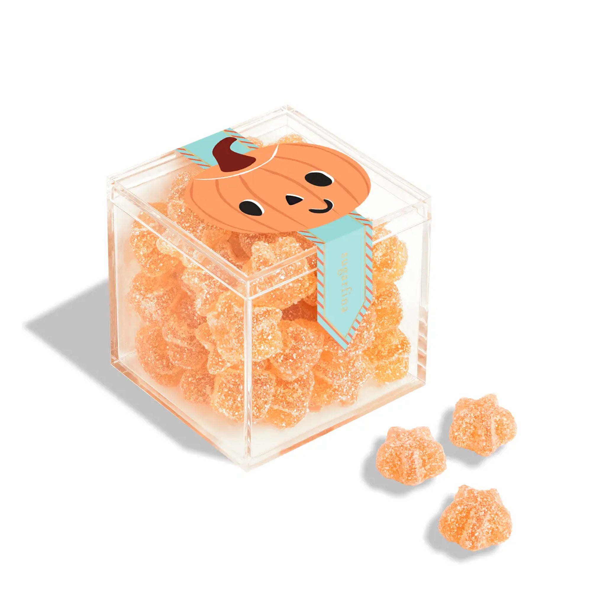 A clear acrylic colored box of orange sour star candies with a pumpkin graphic on the front. 