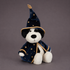 A black and white puppy shaped plush toy wearing a wizard costume. 