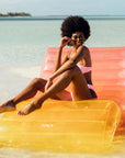 A pink, orange and yellow ombre chaise lounge pool float.