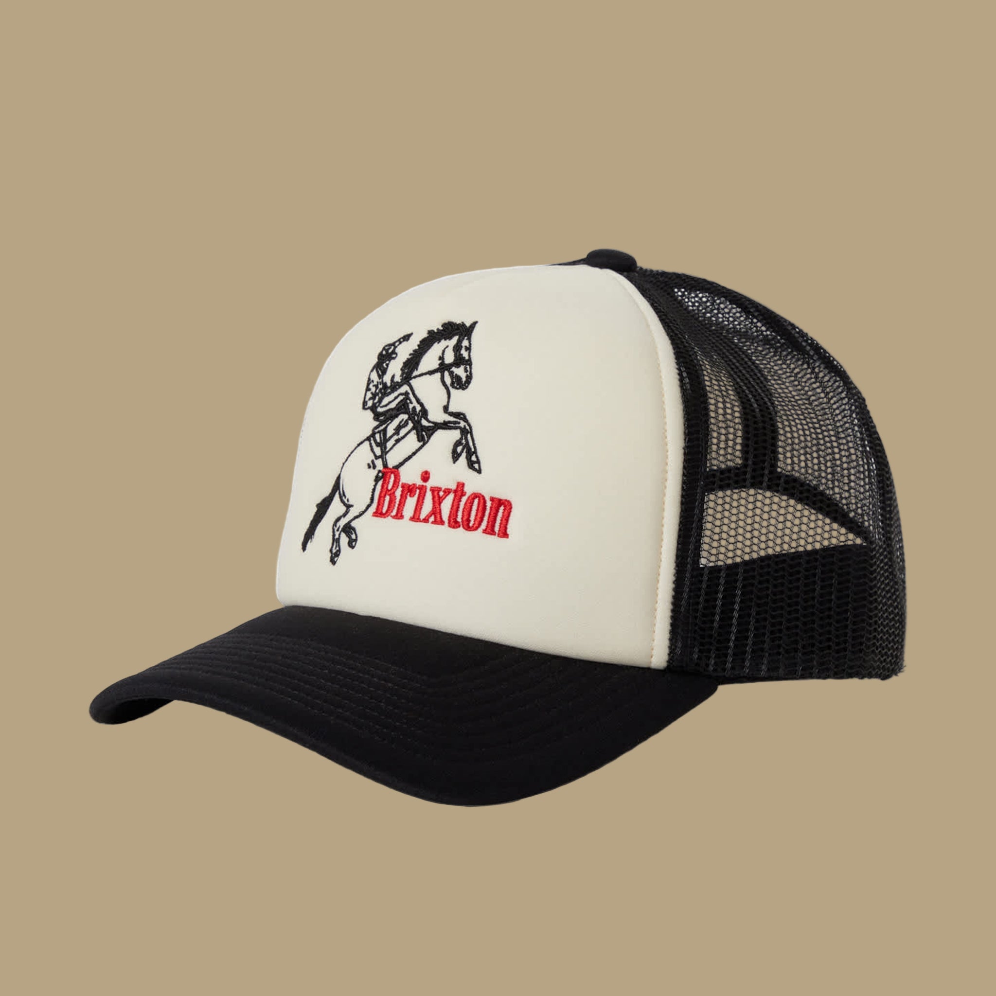 A black and cream colored trucker hat with black embroidered cowboy and horse and red "Brixton". 