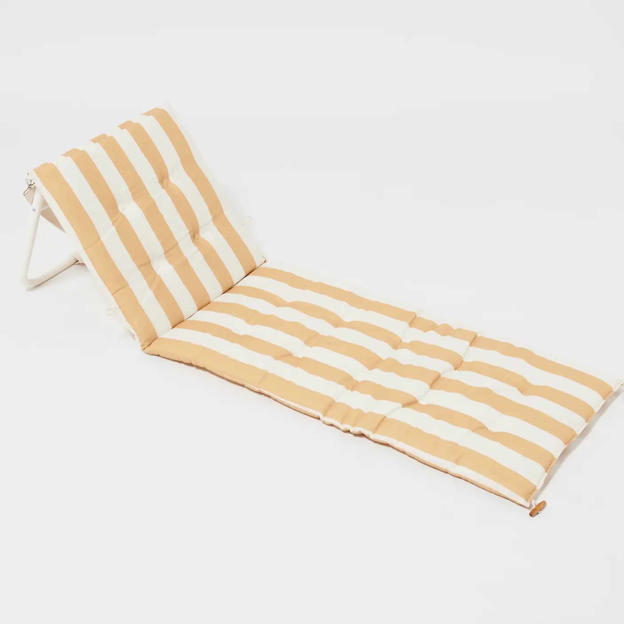 A mustard and ivory striped unfoldable beach or pool chair with folds into a compact square with a strap for carrying.