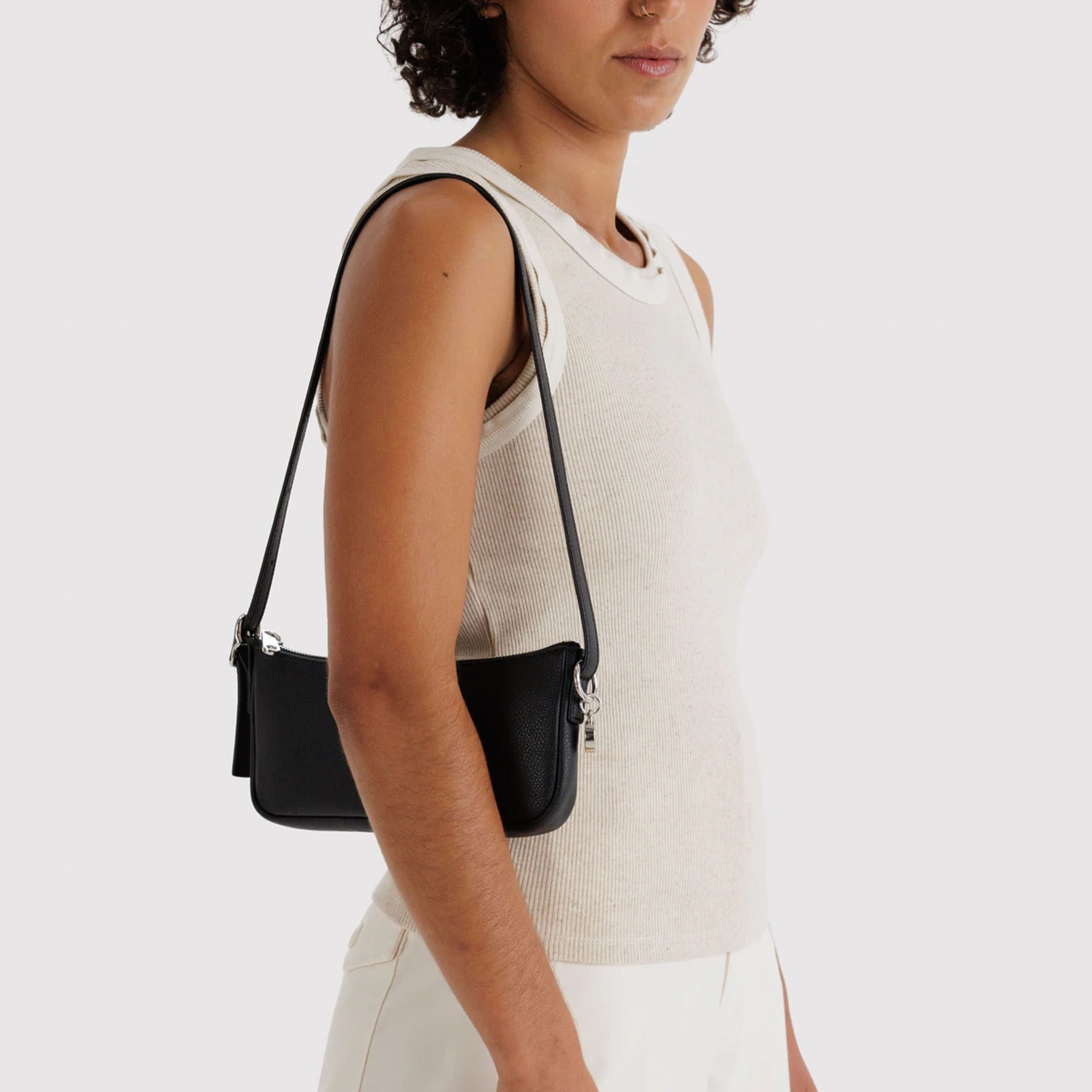 A black recycled leather small shoulder bag. 